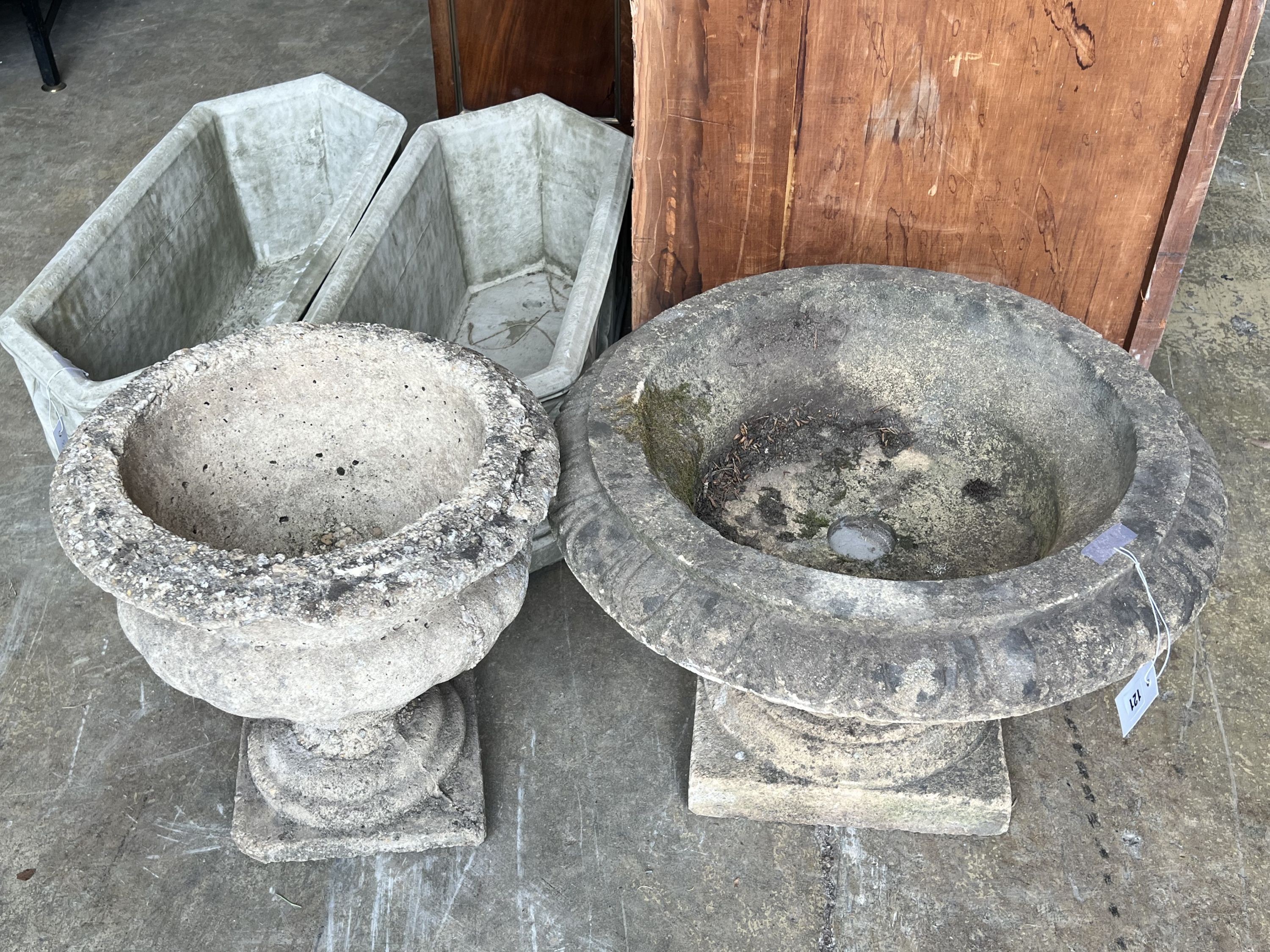 Two reconstituted stone circular campana garden urns, larger diameter 58cm height 38cm
